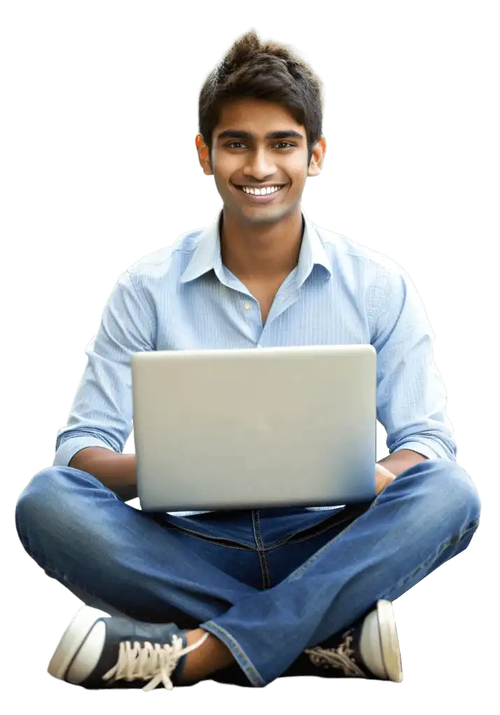 A young male student sits cross-legged on the floor with a laptop balanced on his lap, smiling confidently at the camera. He is wearing a light blue button-up shirt and blue jeans with dark sneakers. The white background gives the image a clean, professional look. This image represents a Brilliko student — a learner enrolled in Brilliko's multimedia courses — embracing digital education with enthusiasm and a modern, tech-forward mindset. Brilliko Institute empowers students like him with industry-ready multimedia skills.